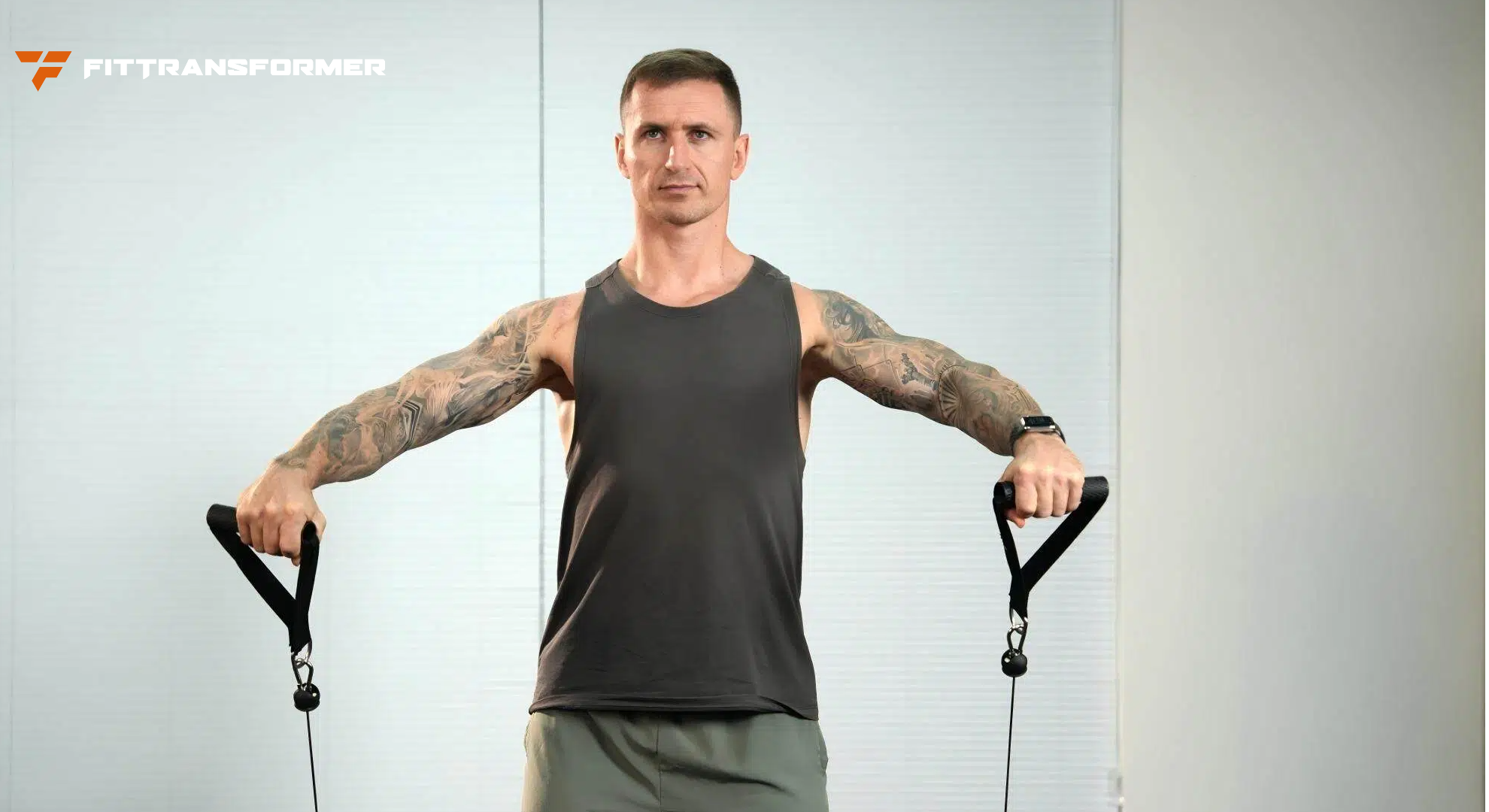 Muscular man performing a cable exercise using FitTransformer handles