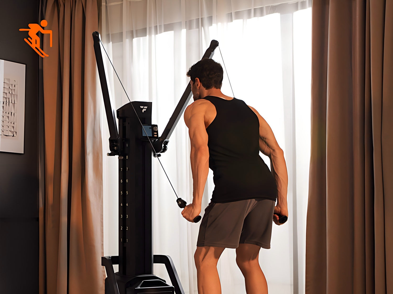A muscular man in a black tank top performing a skiing simulation workout on a dual-arm functional cable machine at home