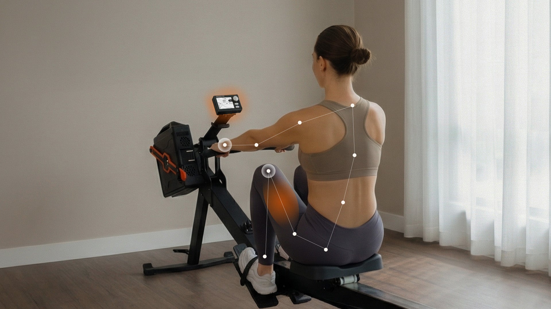 A woman using a rowing machine from a rear-view perspective