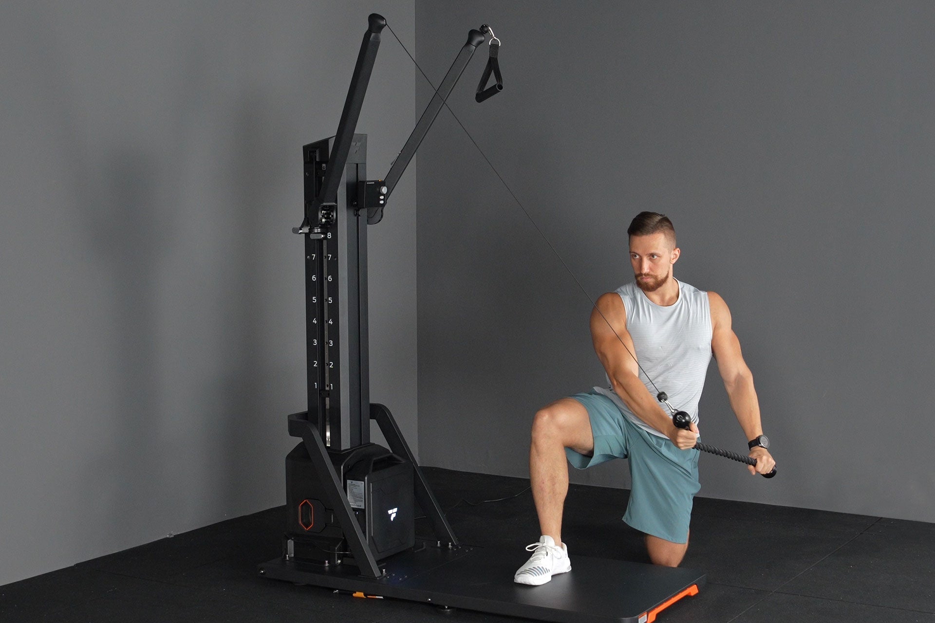 Man performing kneeling cable woodchop on FitTransformer home gym for core and upper body training